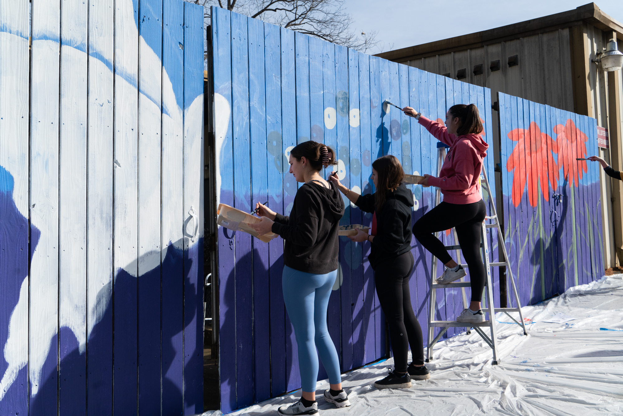 Photo: Volunteers in the early stages of the exterior mural