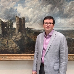 Tim Barringer standing in front of a John Constable painting