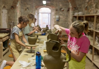 (L-R) Undergraduates Abby Hooper, Maggie Patten, and Caroline Clark work on their pieces in the ceramics studios in the John D. Kehoe Cortona Center.