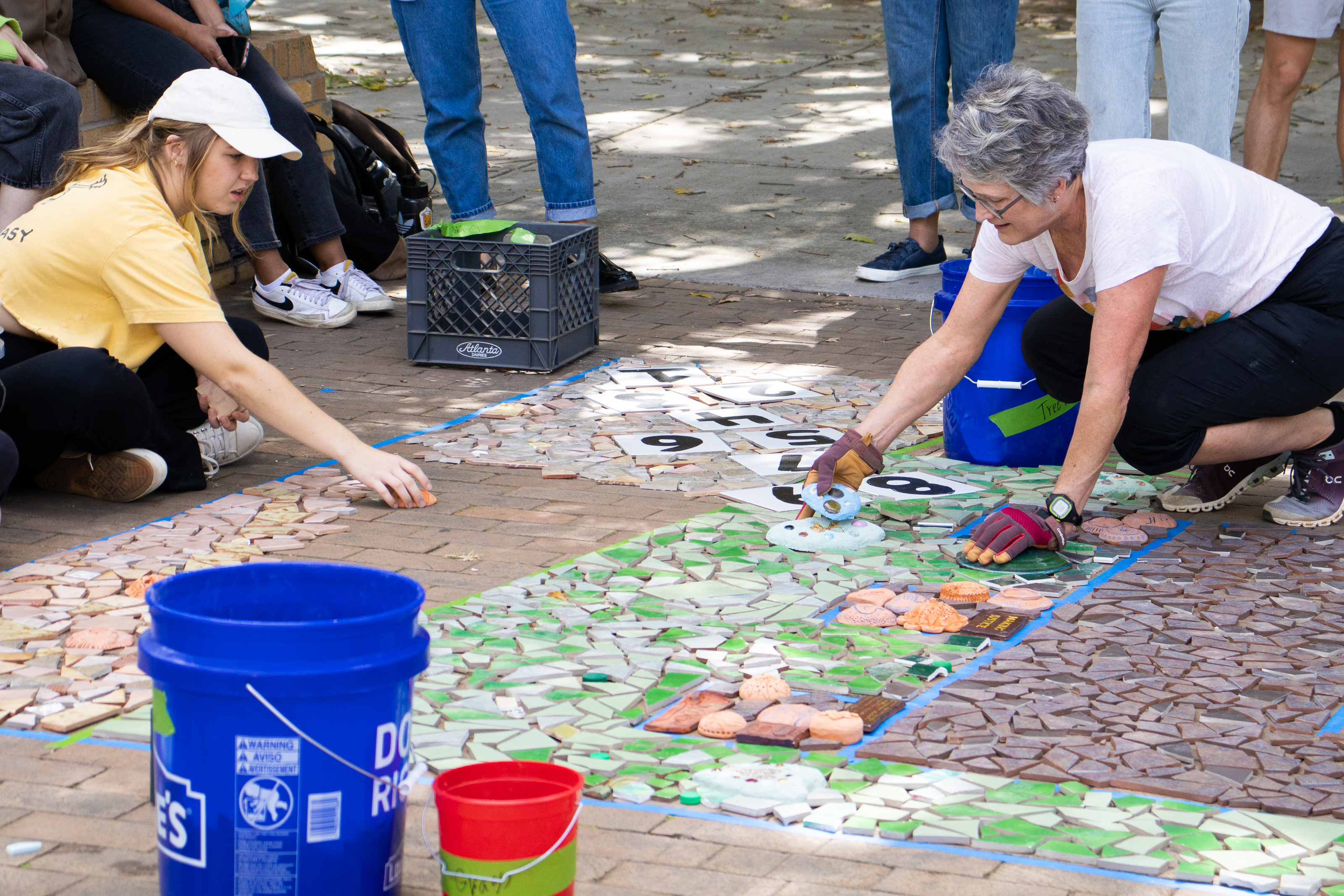 Lynn Sanders-Bustle assembling mosaic with students