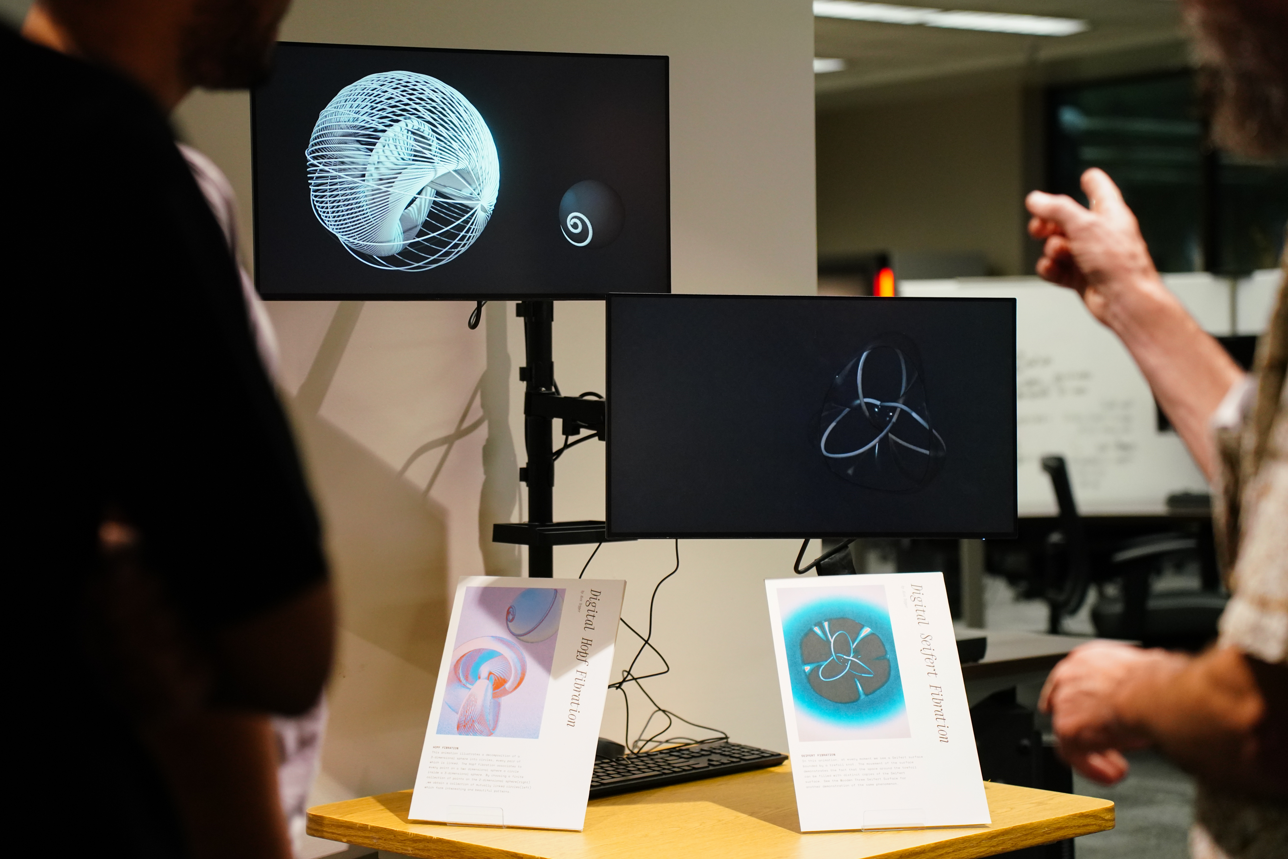 Professor Dave Gay explains digital animations of topological objects by Alex Tepper at the opening of Spacing Out, November 6, 2024. Photo courtesy of Sidney Chansamone.