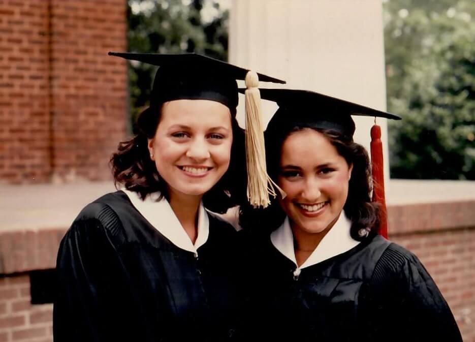 Susan and a friend pose for a graduation photo in 1982 in front of the Kappa Alpha Theta house on Milledge Ave.