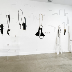 Image of artworks suspended inside gallery space.