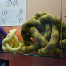 Fabric knots on display with diagrams about the field of Knot Theory on view in Spacing Out at the UGA McBay Science Library. Photo courtesy of Sidney Chansamone.