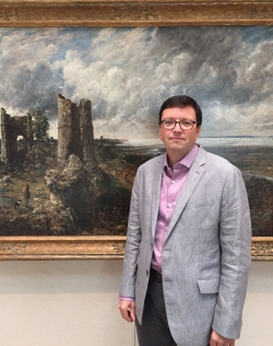 Tim Barringer standing in front of a John Constable painting