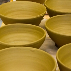 Yellow ceramic bowls in two rows