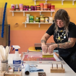 Amanda Burk, owner of Flat File Print Shop, works on a print at her studio on Friday, July 29, 2022 in Athens. Burk has been in the printmaking business for 20 years and opened Flat File Print Shop this past June. Photograph by Kayla Renie, Athens-Banner Herald, USA Today Network.