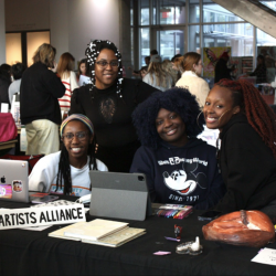 University of Georgia Black Artists Alliance members (L-R) Zahria Cook, Jasmine Best, AJ Aremu and Jordan Campbell pose for a photo behind their joint table at the Dodd market. (Photo/Isabelle Manders)