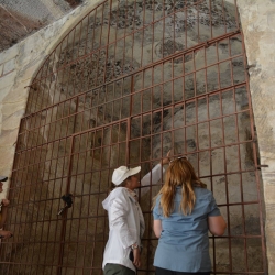 Famous Hellenistic Tomb painting in Little Petra, Jordan in Center, Dr. Jennifer Ramsey on Right