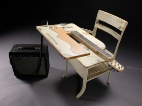 "Rocking Chair I," 2021, Found school desk, guitar components, wood, iron, 21" x 25" x 28".