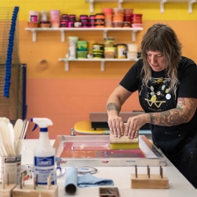 Amanda Burk, owner of Flat File Print Shop, works on a print at her studio on Friday, July 29, 2022 in Athens. Burk has been in the printmaking business for 20 years and opened Flat File Print Shop this past June. Photograph by Kayla Renie, Athens-Banner Herald, USA Today Network.