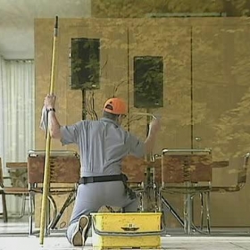 a window washer facing away from the viewer