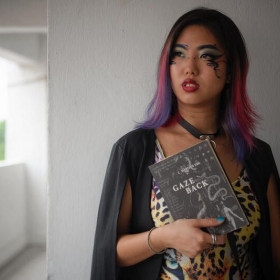 Picture of Marylyn Tan holding a book.