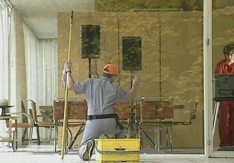 a window washer facing away from the viewer