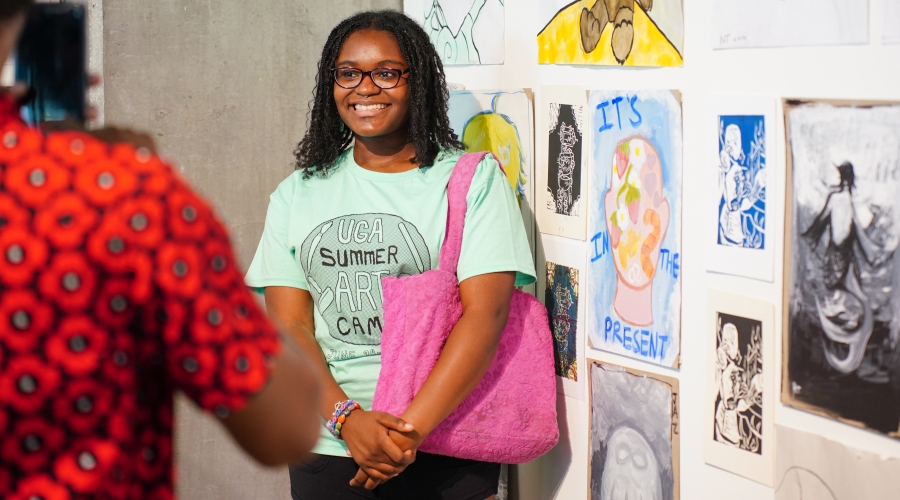 2024 UGA Summer Art Camp participant posing at the closing exhibition reception, June 2024. Photo courtesy of Sidney Chansamone.