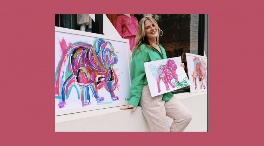 Chandler Sherry posing with colorful bulldog paintings