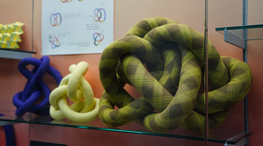 Fabric knots on display with diagrams about the field of Knot Theory on view in Spacing Out at the UGA McBay Science Library. Photo courtesy of Sidney Chansamone.