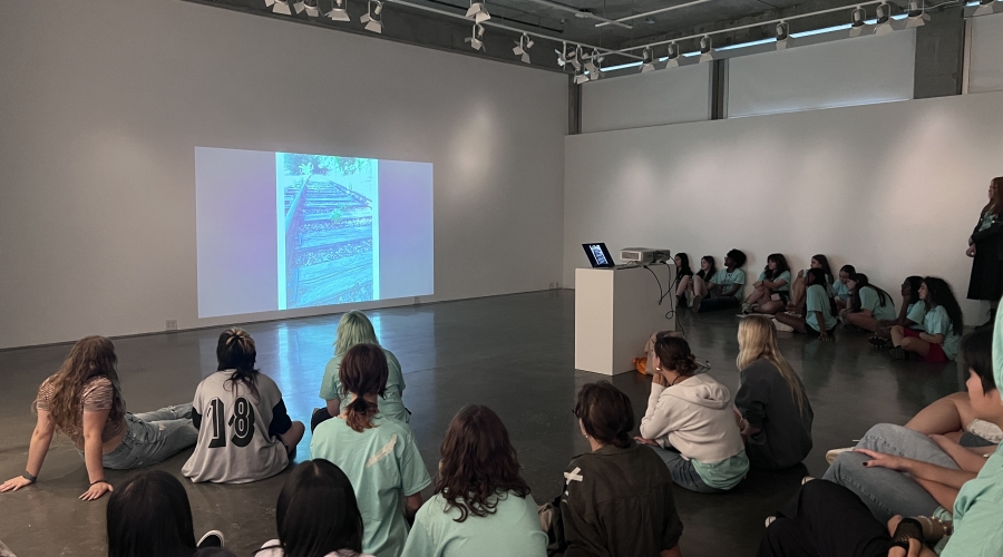 2024 UGA Summer Art Camp participants viewing projected photographs in the Lupin Gallery, June 2024.