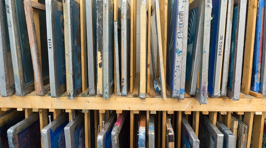 Different silk screen slides are stored in cubbies