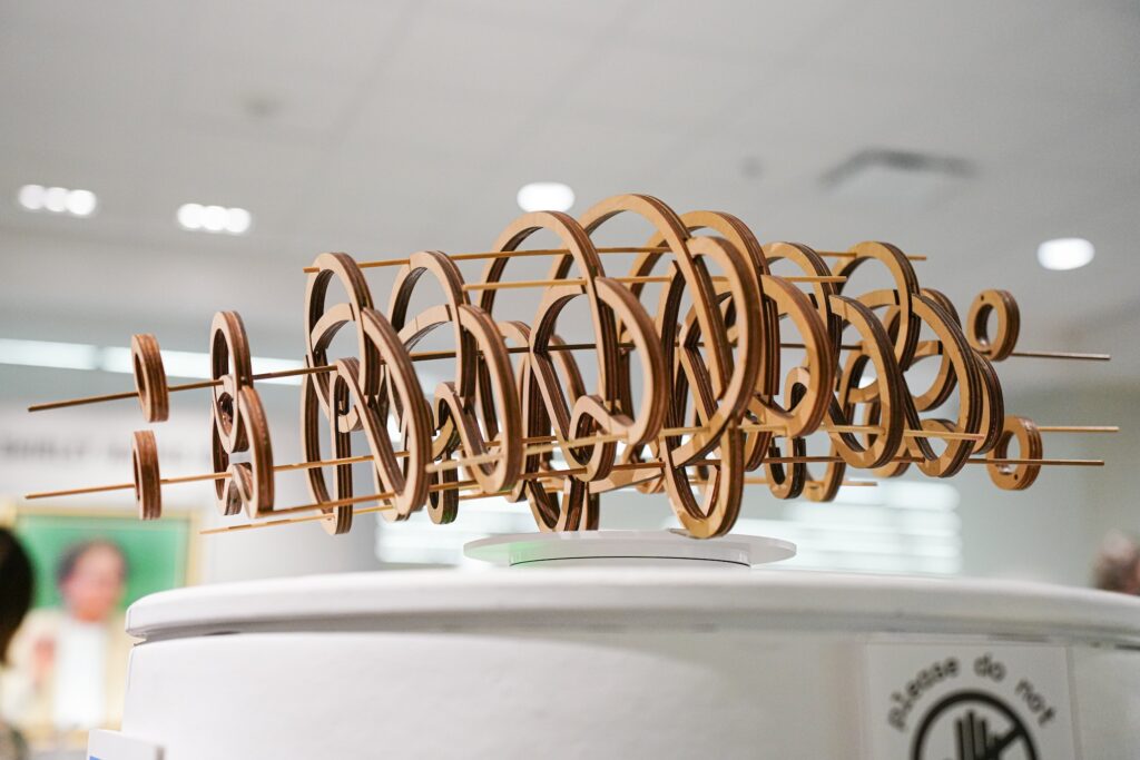 Wood spun knot sculpture by graphic design students on display in Spacing Out at the UGA McBay Science Library. 