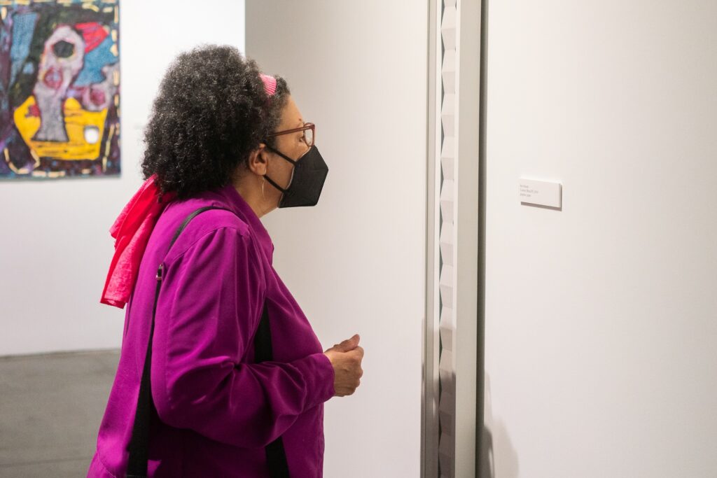 Guest viewing work by Pete Schulte on display in the Margie E. West Gallery.