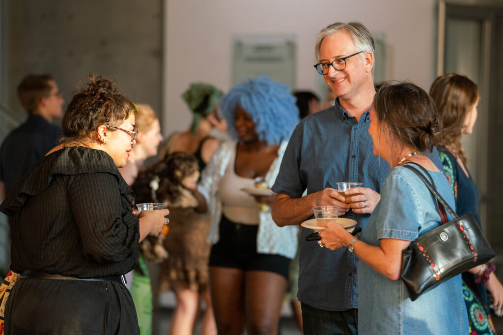 MFA student Shaunia Grant chats with faculty member Mark Callahan and Ashley Callahan.
