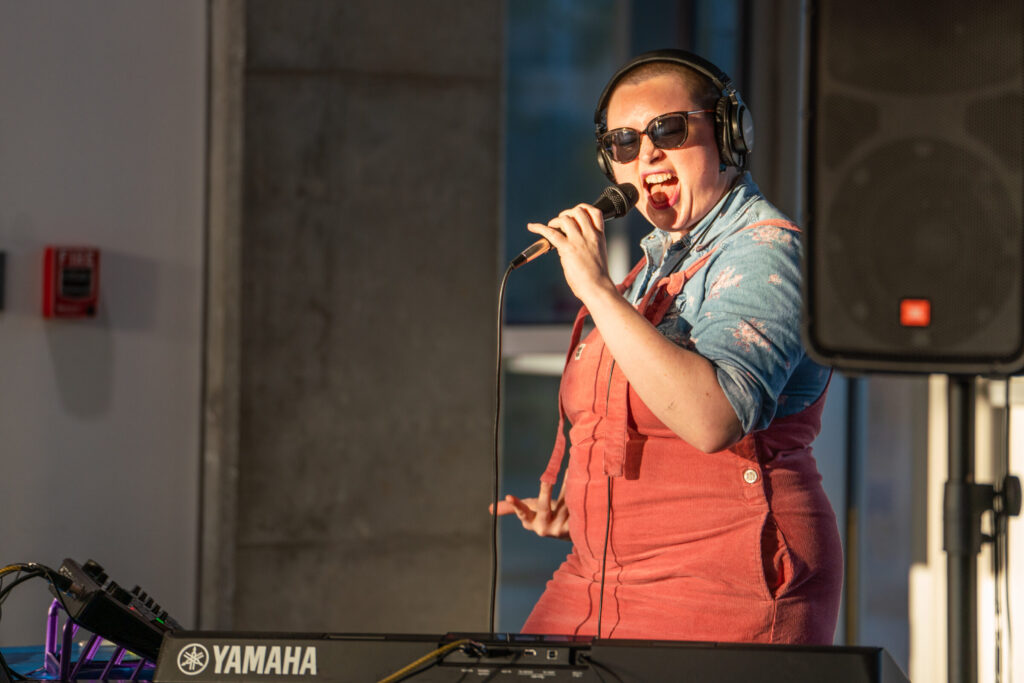 Musician Libba Loops serenades audiences in the School of Art atrium on the first floor.