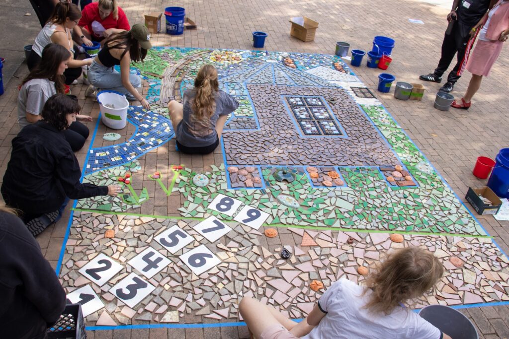 Students and participants assemble the Linnentown Living Mosaic at the University of Georgia Memorial Hall Plaza on October 3, 2022.