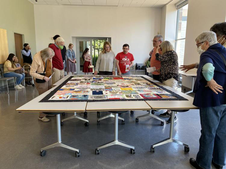 Attendees view the completed quilt from the Linnentown Quilt Project on April 10, 2022 at the Georgia Museum of Art. As they viewed it, many people took photos and talked about the quilt's features. 