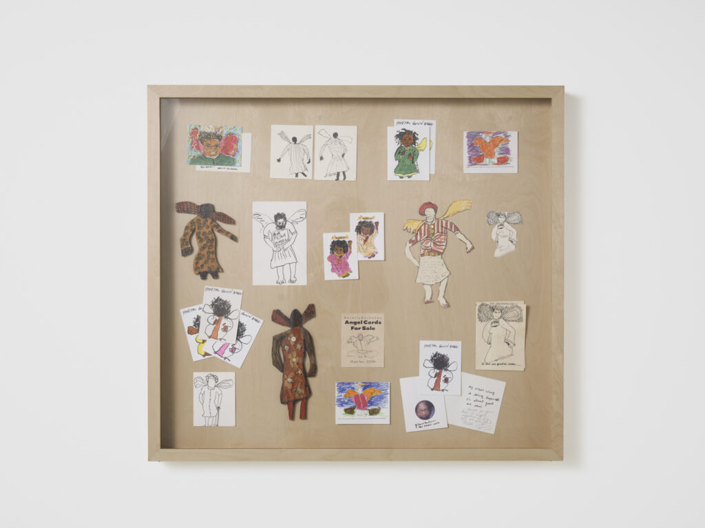 Installation view at the Athenaeum for “Beverly's Athens: Beverly Buchanan in Athens, GA”, Spring 2026. Assembled archival materials (illustrations and note cards) centered on an angel theme on wooden board. Photo courtesy of Walker Bankson.