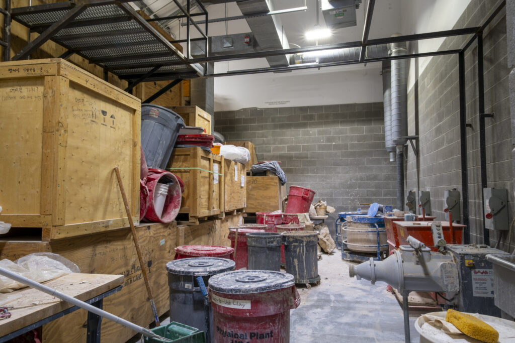 Room with bins of clay and shipping crates