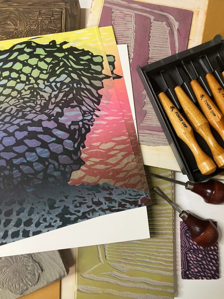 Detail view of multi-colored prints and print making tools